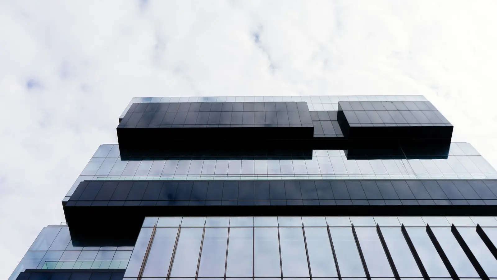 Looking up at the glass and steel facade of a downtown office tower